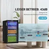 A mini beverage refrigerator filled with cans is shown next to a living room scene with a sofa and coffee table. Overlay graphics highlight sound levels. Produktbild-Vorschau