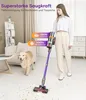 A woman is using a cordless vacuum cleaner in a living room with a dog present. Produktbild-Vorschau