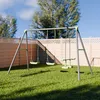 A swing set in a backyard with a wooden fence and trees in the background. Produktbild-Vorschau