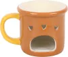 A ceramic mug with heart cutouts and a hollow base, designed to hold a tea light or small candle for aromatherapy. Voir les images du produit