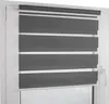 A close-up view of a grey and white striped roller blind installed in a window frame. Produktbild-Vorschau