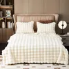 A neatly made bed with a plush blanket and pillows, set against a headboard and a bookshelf. Náhled obrázku produktu