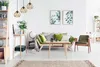 A modern living room with a sofa, armchair, coffee table, and shelving unit. Voir les images du produit