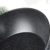 A close-up view of the speckled interior of a black frying pan. Produktbild-Vorschau