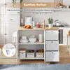 A kitchen island cart with drawers and shelves, shown in a kitchen setting with some food items and kitchenware. Náhľad obrázku produktu