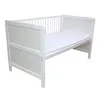A white baby crib with a mattress inside, shown from a side angle against a white background. Produktbild-Vorschau