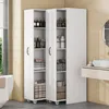 A white storage cabinet with multiple shelves filled with toiletries and towels, placed in a bathroom setting next to a sink and a window. Náhled obrázku produktu