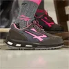 A close-up shot of a pair of women's safety shoes and socks. Podgląd zdjęcia produktu