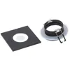 Two parts of a square recessed light fixture are shown on a white background. The left part is a square black trim with a circular opening. The right part is a round metal housing with spring clips. Anteprima dell’immagine prodotto