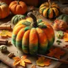 A close-up of a felted pumpkin with autumn leaves and crafting supplies. Produktbild-Vorschau