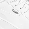 A close-up view of a white Puma sneaker, focusing on the side panel and the Puma logo. Produktbild-Vorschau
