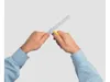 Hands holding a cable knife tool against a plain background. Produktbild-Vorschau