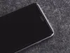 A close-up shot of a smartphone screen protector on a dark, textured surface. Voir les images du produit