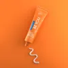 A tube of Curaprox toothpaste with a swirl of toothpaste on an orange background. Anteprima dell’immagine prodotto