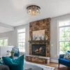 A living room with a fireplace and a ceiling light. Produktbild-Vorschau