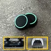 Two black and light green thumbstick grips for a game controller are shown on a textured gray surface. Insets show the bottom of a game controller and a white game controller with colored buttons. Produktbild-Vorschau