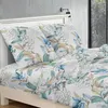 A bed with floral patterned bedding, including pillows and a duvet cover. Produktbild-Vorschau