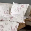 A close-up view of a bed with floral patterned bedding. Produktbild-Vorschau