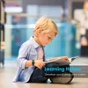 A young boy is sitting on the floor in a library, reading a book. He is wearing a blue shirt and jeans, and a watch on his wrist. There is text overlay on the image. Náhled obrázku produktu