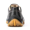 The back view of a black work shoe with a brown sole. Produktbild-Vorschau