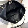 The interior of a black quilted leather tote bag is shown. Náhľad obrázku produktu