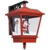 A red Christmas lantern with a Santa Claus figurine inside, set against a white background. Náhľad obrázku produktu