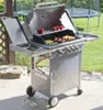 A stainless steel gas grill with food cooking on it, set up on a patio with a grassy backyard and a trampoline in the background. Podgląd zdjęcia produktu