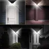 Collage of outdoor lighting scenarios, showing solar-powered wall lights illuminating a front door, a garage pillar, and an entryway. Produktbild-Vorschau