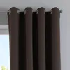 A close-up view of brown curtains hanging from a curtain rod. Produktbild-Vorschau