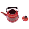 A red enamel teapot with decorative patterns and its lid are shown against a white background. Voir les images du produit