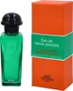 A bottle of Hermès Eau de Basilic Pourpre cologne and its orange and green packaging are displayed against a white background. Voir les images du produit
