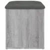 A front view of a storage ottoman with a gray upholstered top and a wood-effect base. Anteprima dell’immagine prodotto