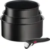 A set of three black nesting pots and a detachable handle are shown against a white background. Voir les images du produit