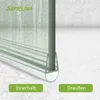 A close-up view of a shower door seal with water droplets on the glass and floor, indicating its water-repellent function. Two green buttons labeled 'Innerhalb' (Inside) and 'Draußen' (Outside) are visible at the bottom. Produktbild-Vorschau