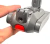 A hand holding a gray vacuum cleaner battery with a red button. Podgląd zdjęcia produktu