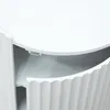 A close-up view of a white side table with a drawer partially open, revealing the interior and a fluted design on the drawer front. Anteprima dell’immagine prodotto