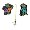 Two cartoon-style character charms and a ninja star charm on a string, against a white background. Náhled obrázku produktu