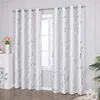 A pair of white curtains with a silver marble pattern hanging in front of a window. Produktbild-Vorschau