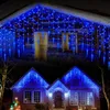 A collage of two images showing houses decorated with blue icicle-shaped LED lights for Christmas. Produktbild-Vorschau