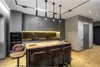 A modern kitchen with a large island and bar stools. Produktbild-Vorschau
