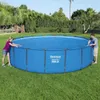 Two people are standing next to a large blue above-ground swimming pool on a grassy lawn. Náhled obrázku produktu
