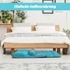 A bedroom scene with a bed and a folded floor sofa in front of it. Voir les images du produit