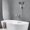 A modern bathroom with a white bathtub and a chrome faucet with a handheld showerhead. Produktbild-Vorschau