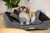 A small dog is standing in a large dog bed indoors. Anteprima dell’immagine prodotto