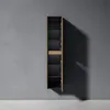 A tall, narrow cabinet with a light wood finish and black shelves is shown mounted on a gray wall. Anteprima dell’immagine prodotto