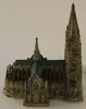 A miniature model of a cathedral with a tall spire and green roof, set against a plain white background. Produktbild-Vorschau