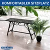 A black metal garden bench with decorative scrollwork is placed on a wooden deck, with lush green plants in the background and a potted plant to the right. Náhľad obrázku produktu