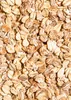 A close-up, overhead view of a pile of mixed grain flakes. Produktbild-Vorschau