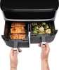Hands pulling out two drawers from a black air fryer, one filled with salmon fillets and the other with cooked vegetables. Produktbild-Vorschau