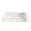 A white wooden daybed with a built-in bookshelf headboard and side rails, shown from a slightly elevated side angle against a white background. Voir les images du produit